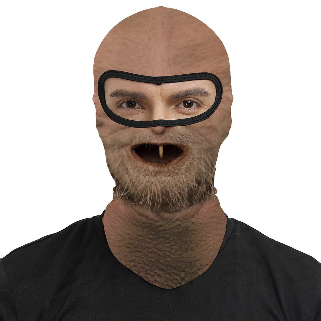 One Tooth Willie funny face balaclava, printed dropped jaw, one tooth and scruffy beard, worn by a man, front view, eyes visible through the open eye band