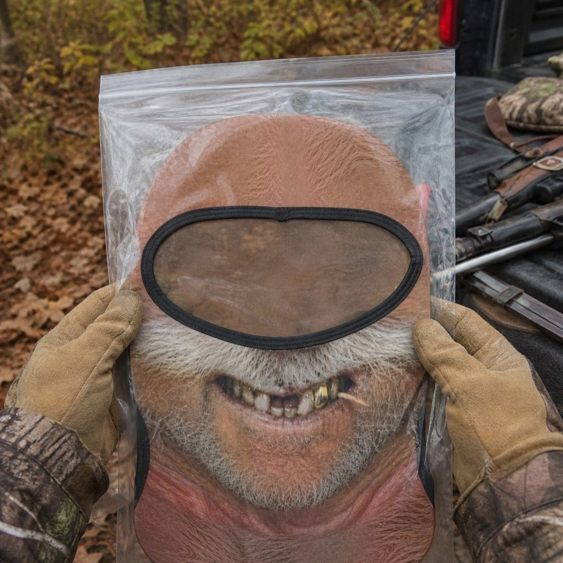 Big Stache Bubba funny face balaclava laid flat in a clear bag, held up to show the full print