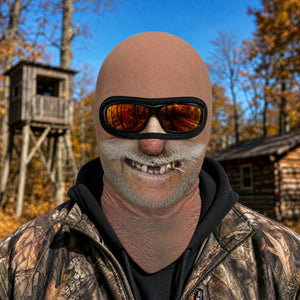 Big Stache Bubba full face balaclava worn with orange goggles over the eye opening, printed nose and white handlebar mustache, hunting camp
