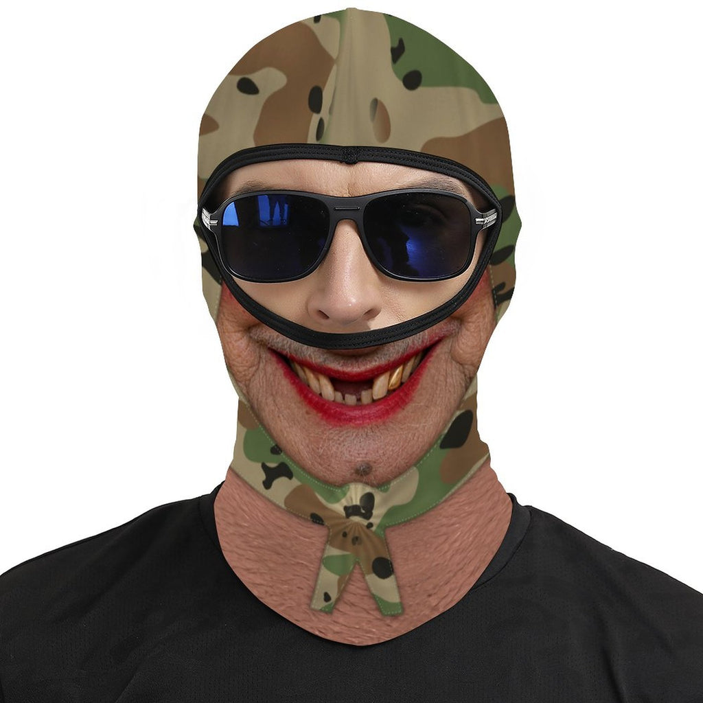 Gold Tooth Granny funny face balaclava, printed camo head scarf, red lipstick and gold tooth, worn with blue sunglasses over the open eye band, front view