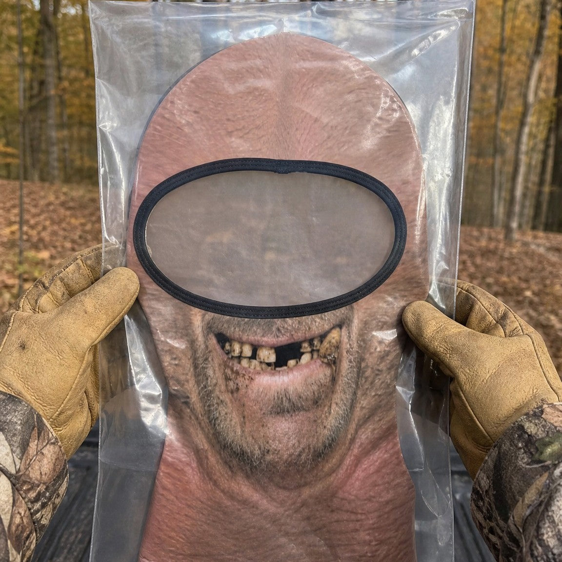 Toothless Tom funny face balaclava laid flat in a clear bag, held up to show the full print